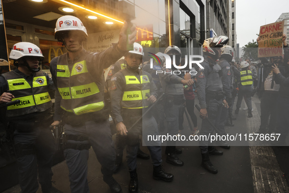 Protesters hold a demonstration against the fires and the climate situation in Brazil and for agrarian reform on Avenida Paulista, in the ce...