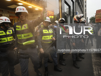 Protesters hold a demonstration against the fires and the climate situation in Brazil and for agrarian reform on Avenida Paulista, in the ce...