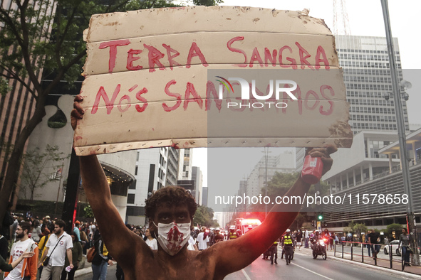 Protesters hold a demonstration against the fires and the climate situation in Brazil and for agrarian reform on Avenida Paulista, in the ce...