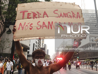 Protesters hold a demonstration against the fires and the climate situation in Brazil and for agrarian reform on Avenida Paulista, in the ce...