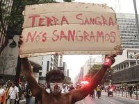 Protesters hold a demonstration against the fires and the climate situation in Brazil and for agrarian reform on Avenida Paulista, in the ce...