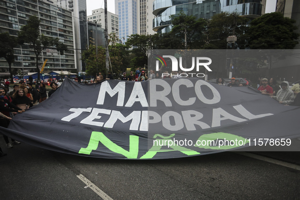 Protesters hold a demonstration against the fires and the climate situation in Brazil and for agrarian reform on Avenida Paulista, in the ce...