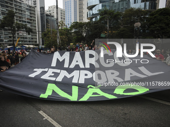 Protesters hold a demonstration against the fires and the climate situation in Brazil and for agrarian reform on Avenida Paulista, in the ce...