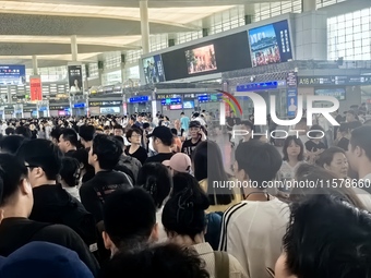 A large number of tourists prepare to travel at Chengdu East Railway Station on the first day of the Mid-Autumn Festival holiday in Chengdu,...