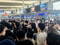 A large number of tourists prepare to travel at Chengdu East Railway Station on the first day of the Mid-Autumn Festival holiday in Chengdu,...