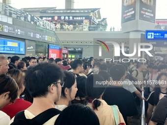 A large number of tourists prepare to travel at Chengdu East Railway Station on the first day of the Mid-Autumn Festival holiday in Chengdu,...