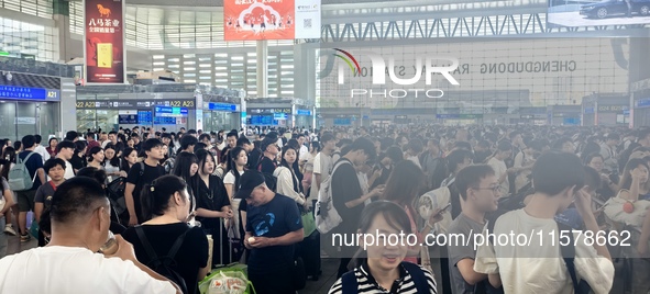 A large number of tourists prepare to travel at Chengdu East Railway Station on the first day of the Mid-Autumn Festival holiday in Chengdu,...