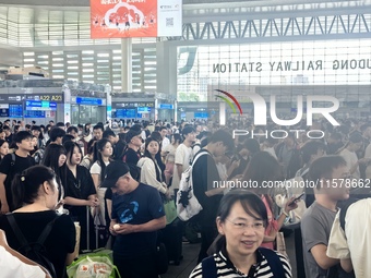 A large number of tourists prepare to travel at Chengdu East Railway Station on the first day of the Mid-Autumn Festival holiday in Chengdu,...