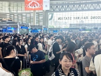 A large number of tourists prepare to travel at Chengdu East Railway Station on the first day of the Mid-Autumn Festival holiday in Chengdu,...