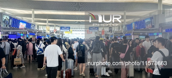 A large number of tourists prepare to travel at Chengdu East Railway Station on the first day of the Mid-Autumn Festival holiday in Chengdu,...