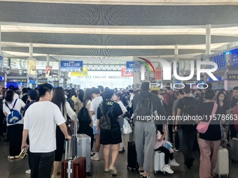 A large number of tourists prepare to travel at Chengdu East Railway Station on the first day of the Mid-Autumn Festival holiday in Chengdu,...