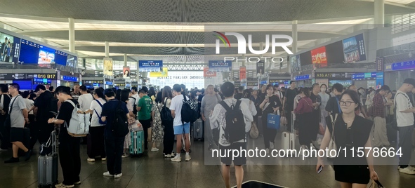 A large number of tourists prepare to travel at Chengdu East Railway Station on the first day of the Mid-Autumn Festival holiday in Chengdu,...