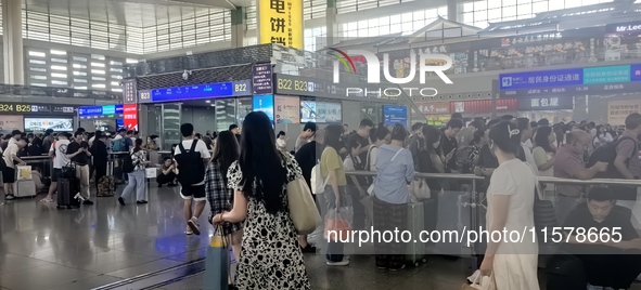 A large number of tourists prepare to travel at Chengdu East Railway Station on the first day of the Mid-Autumn Festival holiday in Chengdu,...