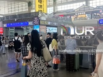 A large number of tourists prepare to travel at Chengdu East Railway Station on the first day of the Mid-Autumn Festival holiday in Chengdu,...