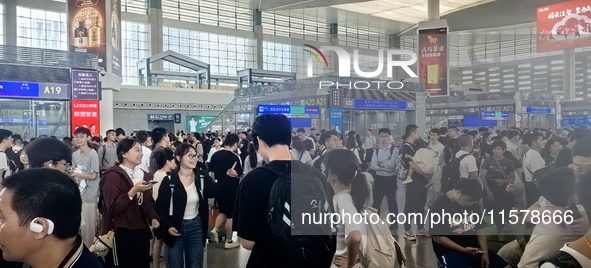 A large number of tourists prepare to travel at Chengdu East Railway Station on the first day of the Mid-Autumn Festival holiday in Chengdu,...