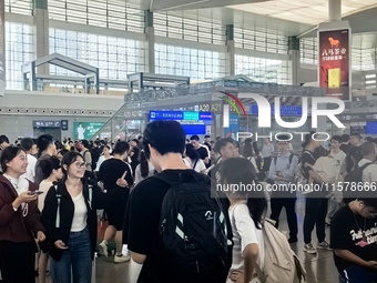 A large number of tourists prepare to travel at Chengdu East Railway Station on the first day of the Mid-Autumn Festival holiday in Chengdu,...