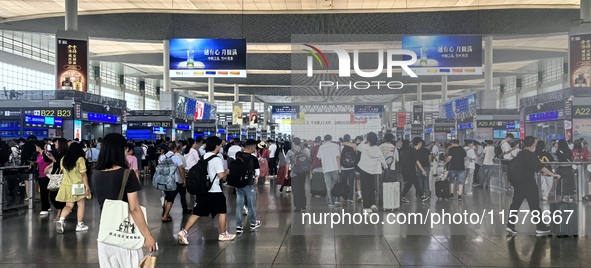 A large number of tourists prepare to travel at Chengdu East Railway Station on the first day of the Mid-Autumn Festival holiday in Chengdu,...