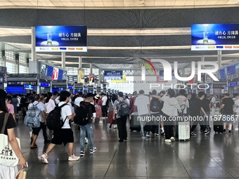 A large number of tourists prepare to travel at Chengdu East Railway Station on the first day of the Mid-Autumn Festival holiday in Chengdu,...