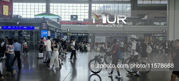 A large number of tourists prepare to travel at Chengdu East Railway Station on the first day of the Mid-Autumn Festival holiday in Chengdu,...