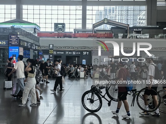 A large number of tourists prepare to travel at Chengdu East Railway Station on the first day of the Mid-Autumn Festival holiday in Chengdu,...