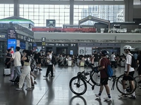 A large number of tourists prepare to travel at Chengdu East Railway Station on the first day of the Mid-Autumn Festival holiday in Chengdu,...