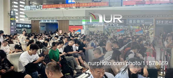 A large number of tourists prepare to travel at Chengdu East Railway Station on the first day of the Mid-Autumn Festival holiday in Chengdu,...