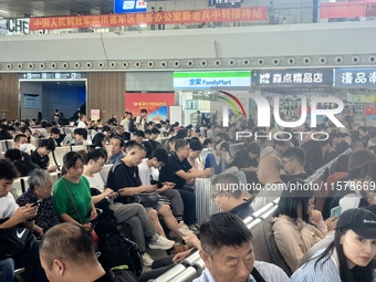 A large number of tourists prepare to travel at Chengdu East Railway Station on the first day of the Mid-Autumn Festival holiday in Chengdu,...