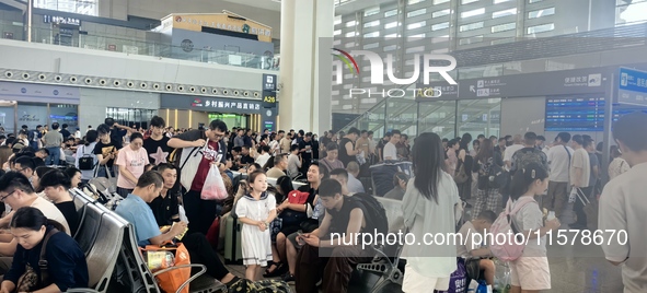 A large number of tourists prepare to travel at Chengdu East Railway Station on the first day of the Mid-Autumn Festival holiday in Chengdu,...