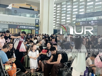 A large number of tourists prepare to travel at Chengdu East Railway Station on the first day of the Mid-Autumn Festival holiday in Chengdu,...