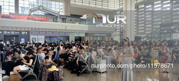 A large number of tourists prepare to travel at Chengdu East Railway Station on the first day of the Mid-Autumn Festival holiday in Chengdu,...