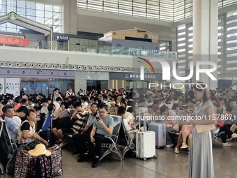 A large number of tourists prepare to travel at Chengdu East Railway Station on the first day of the Mid-Autumn Festival holiday in Chengdu,...