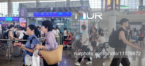 A large number of tourists prepare to travel at Chengdu East Railway Station on the first day of the Mid-Autumn Festival holiday in Chengdu,...