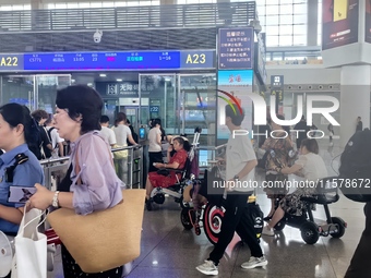 A large number of tourists prepare to travel at Chengdu East Railway Station on the first day of the Mid-Autumn Festival holiday in Chengdu,...