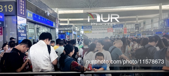 A large number of tourists prepare to travel at Chengdu East Railway Station on the first day of the Mid-Autumn Festival holiday in Chengdu,...