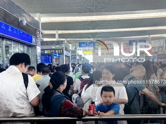 A large number of tourists prepare to travel at Chengdu East Railway Station on the first day of the Mid-Autumn Festival holiday in Chengdu,...