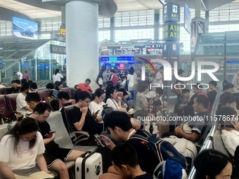 A large number of tourists prepare to travel at Chengdu East Railway Station on the first day of the Mid-Autumn Festival holiday in Chengdu,...