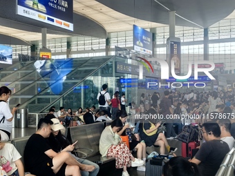 A large number of tourists prepare to travel at Chengdu East Railway Station on the first day of the Mid-Autumn Festival holiday in Chengdu,...