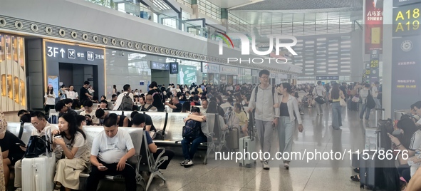 A large number of tourists prepare to travel at Chengdu East Railway Station on the first day of the Mid-Autumn Festival holiday in Chengdu,...