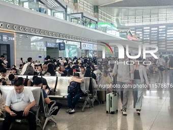 A large number of tourists prepare to travel at Chengdu East Railway Station on the first day of the Mid-Autumn Festival holiday in Chengdu,...