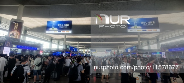 A large number of tourists prepare to travel at Chengdu East Railway Station on the first day of the Mid-Autumn Festival holiday in Chengdu,...