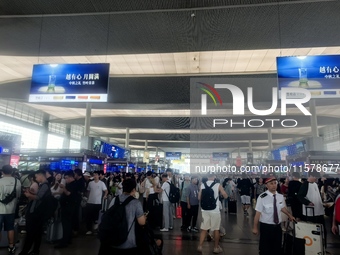 A large number of tourists prepare to travel at Chengdu East Railway Station on the first day of the Mid-Autumn Festival holiday in Chengdu,...