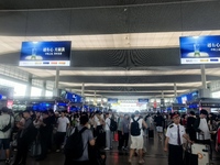 A large number of tourists prepare to travel at Chengdu East Railway Station on the first day of the Mid-Autumn Festival holiday in Chengdu,...