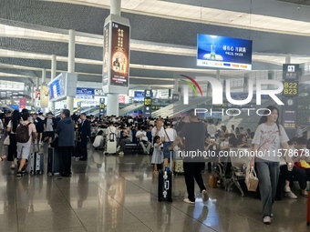 A large number of tourists prepare to travel at Chengdu East Railway Station on the first day of the Mid-Autumn Festival holiday in Chengdu,...