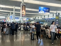 A large number of tourists prepare to travel at Chengdu East Railway Station on the first day of the Mid-Autumn Festival holiday in Chengdu,...