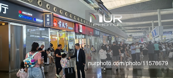 A large number of tourists prepare to travel at Chengdu East Railway Station on the first day of the Mid-Autumn Festival holiday in Chengdu,...