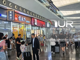 A large number of tourists prepare to travel at Chengdu East Railway Station on the first day of the Mid-Autumn Festival holiday in Chengdu,...