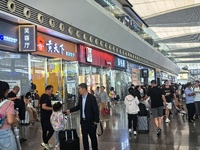 A large number of tourists prepare to travel at Chengdu East Railway Station on the first day of the Mid-Autumn Festival holiday in Chengdu,...