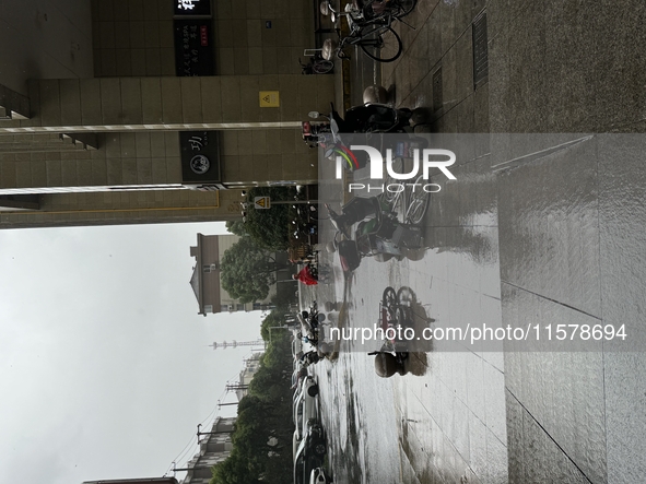 Electric bikes are blown down during strong winds and rain as Typhoon Bebika makes landfall in Shanghai, China, on September 16, 2024. 