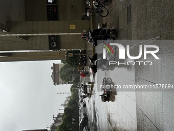 Electric bikes are blown down during strong winds and rain as Typhoon Bebika makes landfall in Shanghai, China, on September 16, 2024. (