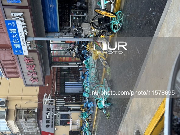 Shared bicycles are blown down during heavy winds and rain as Typhoon Bebika makes landfall in Shanghai, China, on September 16, 2024. 